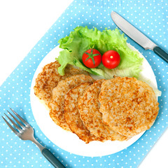 A potato pancakes with lettuce and tomatos on blue napkin