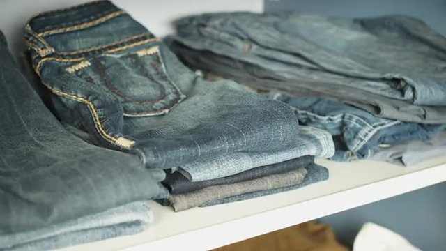 Shelf with jeans in the closet