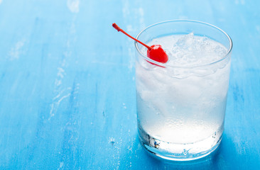 Old fashioned cocktail with cherry