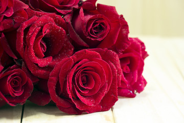 Bouquet of red roses on a wooden background