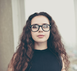 Portrait of a thoughtful  businesswoman standing near window