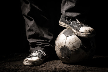 Ragged sneakers with a soccer ball