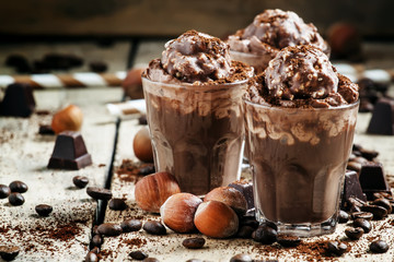 Chocolate-Coffee dessert with whipped cream, nuts and chocolates