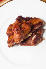 Roasted pork ribs on a white plate