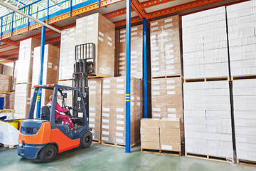 forklift loader working in warehouse  © Kadmy