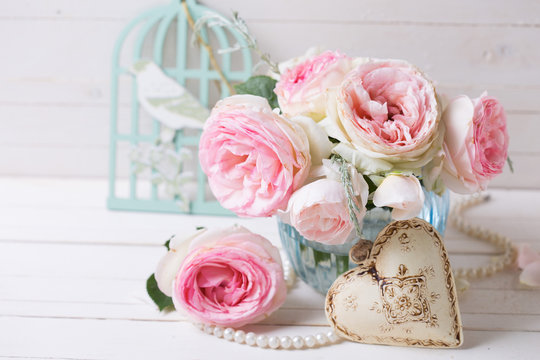Background with  pink roses flowers  in blue vase and decorative