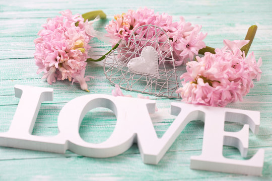 Pink hyacinths flowers, decorative heart and wooden word love  o