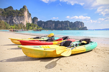 Fototapeta na wymiar Kayaks on a tropical beach, active holidays concept.