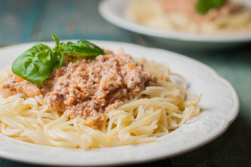 A plate of spaghetti with creamy tomato meat sauce