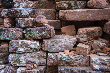 Old and broken red stone brick wall