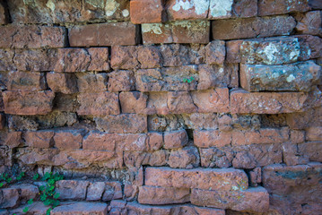Old and broken red stone brick wall