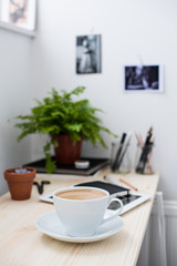 Fototapeta na wymiar Cup of coffe in modern loft-style office