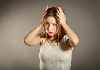 Closeup portrait displeased, pissed off, angry, grumpy, pessimistic, woman with hands on head with bad headache. Negative human emotions face expression feelings life perception