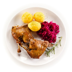 Roast duck legs and vegetables