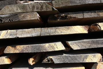 Ends of the rough pine boards in the outdoor stack