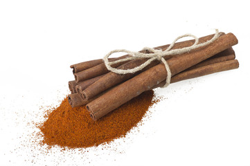 cinnamon sticks with powder on the white background