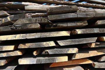 Ends of the rough pine boards in the outdoor stack