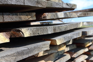 Ends of the rough pine boards in the outdoor stack