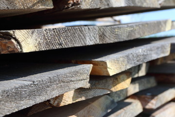Ends of the rough pine boards in the outdoor stack