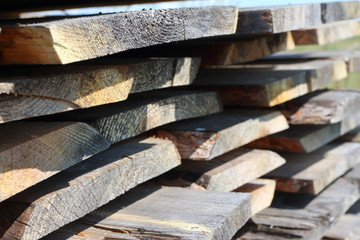 Ends of the rough pine boards in the outdoor stack