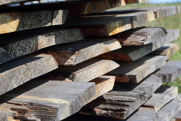 Ends of the rough pine boards in the outdoor stack