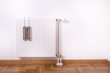 Air humidifier container on radiator - obrazy, fototapety, plakaty
