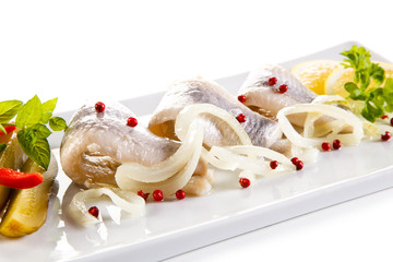 Marinated herring fillets on white background