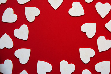 multiple hearts whites shapes, forming a circular frame, red bac