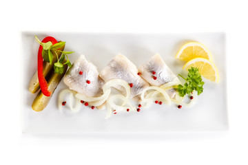 Marinated herring fillets on white background