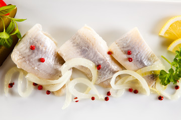 Marinated herring fillets on white background