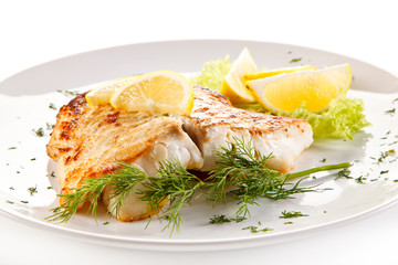 Fototapeta na wymiar Fish dish - fried fish fillet and vegetables