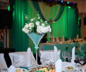 Bunch of white roses at a festive wedding table