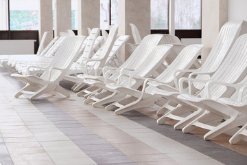 Many white empty chaise-longue
