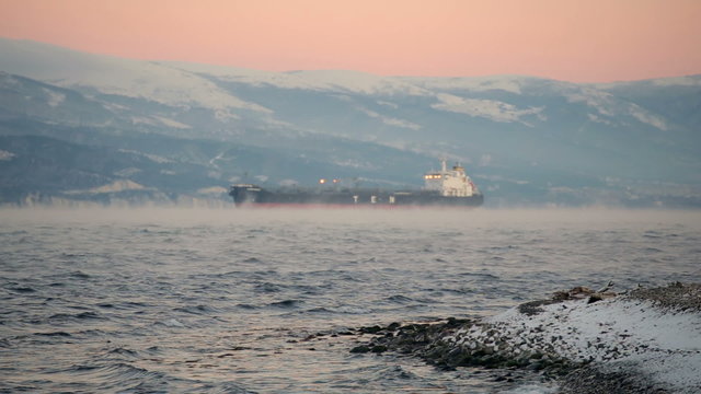 Oil Tanker At sunset/ Oil tanker at night is refuelling. Prominent vibrations in the air. 