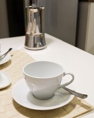 Empty Cup of Coffee with French Press Pot