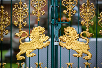 Gold carved lions at the gate of the temple