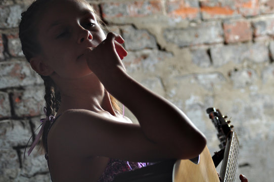 young teenage girl with guitar
