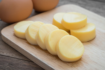 Egg tofu on wooden cutting board and eggs