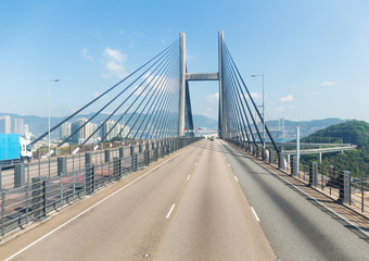 Fototapeta na wymiar Suspension bridge in Hong Kong with clear blue sky
