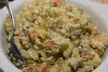 potato salad in a bowl with a spoon