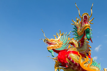 Fototapeta na wymiar Dragon head on blue sky background