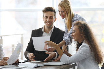 Young business people discussing a new project at the meeting in office