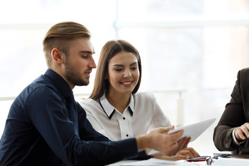 Young business people discussing a new project at the meeting in office
