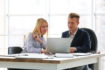 Businessman and businesswoman working in office