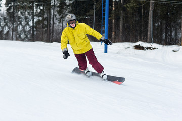 Fototapeta na wymiar snowboarder slides from the mountain