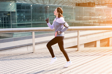 Young attractive woman running downtown