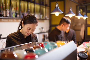 waitress serving in modern cafe