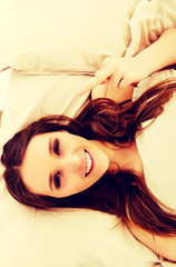 Woman showing middle finger in bedroom.