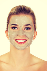Young happy woman with facial mask.