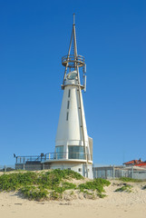 Cone shaped lighthouse on the beach